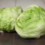 Heads of lettuce on a wooden surface
