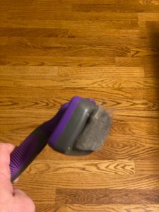 Picture of the GM Pets self cleaning slicker brush with dog hair in it